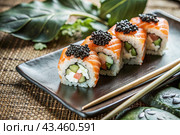 Japanese food. Sushi rolls California, Philadelphia with eel, red caviar and salmon. The concept of the sushi bar menu. Стоковое AI-изображение, AI-художник Photojuli / Фотобанк Лори