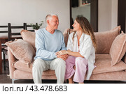 Happy adult daughter and senior father having fun enjoying talk sit on sofa at home. Стоковое фото, фотограф Гладских Татьяна / Фотобанк Лори