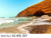 Spectacular natural red arch on atlantic ocean coast, Legzira (or Gzira) beach. Red archs on atlantic ocean coast. Sidi Ifni, Morocco, Africa (2024 год). Стоковое фото, фотограф Евгений Ткачёв / Фотобанк Лори