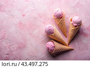 Sweet dessert. Ice cream cones with different flavors on a concrete pink background. World Ice Cream Day. Стоковое AI-изображение, AI-художник Photojuli / Фотобанк Лори