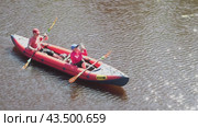 Russia, Sosnovy Bor, June 27, 2024: Two people paddle a kayak down a river. Редакционное видео, видеограф Андрей Знаменский / Фотобанк Лори