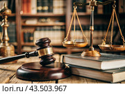 Justice and the law. A wooden hammer, books and scales on the table. The court session. Стоковое AI-изображение, AI-художник Photojuli / Фотобанк Лори