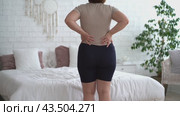 Back pain, kidney inflammation, woman suffering from backache at home. Стоковое видео, видеограф Станислав Тарко / Фотобанк Лори