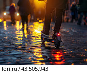 Person Riding Electric Scooter on Wet Cobblestone Street at Sunset. Стоковое AI-изображение, AI-художник Кирилл Черезов / Фотобанк Лори