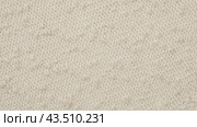 Soft Knitted Woolen Detailed Texture. Natural Fabric Closeup Knit Pattern. Beige Knitwear, Warm Cashmere Surface. Rotation, Macro. Cozy Creamy Textile Background. Clothes Production. Melange Yarn. 4K. Стоковое видео, видеограф Марина Демидюк / Фотобанк Лори