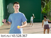 Portrait of caucasian boy standing on frontenis court, holding racket and ball. Стоковое фото, фотограф Яков Филимонов / Фотобанк Лори