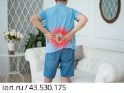 Lumbar intervertebral spine hernia, man with back pain at home, spinal disc disease. Стоковое фото, фотограф Станислав Тарко / Фотобанк Лори
