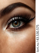 The image shows a close-up of a person's face, focusing on their eye with a beautifully shaped lid and long, full lashes. Стоковое AI-изображение, AI-художник Aleksandr Golubev / Фотобанк Лори