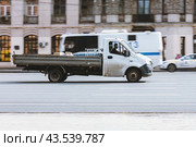 Flatbed truck vehicle in motion on city road. Fast moving car on urban street. Редакционное фото, фотограф Константин Григорьев / Фотобанк Лори