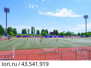 Moscow, Russia, June 2018: View of the training players on a football stadium with searchlights and tribune in the city park (editorial) Редакционное фото, фотограф Михаил Строгалев / Фотобанк Лори