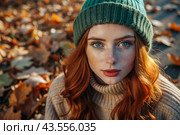 Autumn portrait. Close-up of a red-haired young woman with expressive green eyes in a knitted hat and sweater. Стоковое AI-изображение, AI-художник Photojuli / Фотобанк Лори