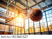 A basketball is flying into the ring on the basketball court. A goal. The ball is in close-up. Стоковое AI-изображение, AI-художник Photojuli / Фотобанк Лори