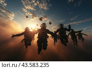 A group of paratroopers making a jump against the backdrop of sunset. They are dressed in black suits and helmets that protect their heads and faces. The sun shines through the clouds, creating dramatic lighting and long shadows. The skydivers are positioned in various positions, some with their arms extended forward, others to the sides. Parachute canopies are visible in the sky, ready to open. The atmosphere of the stage is exciting and filled with adrenaline. Стоковое AI-изображение, AI-художник Анна Кривицкая / Фотобанк Лори