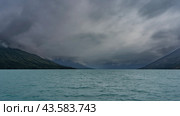 The beautiful glacial lake is surrounded by mountains. Ripples on the turquoise water. Cloudy. Fog. Lago Argentino. El Calafate. Los Glaciares National Park. Argentina. Стоковое фото, фотограф Вера Ивановна Кубарева / Фотобанк Лори