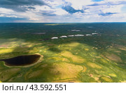 Arctic tundra in summer from an altitude of 2000 meters. Cloudy sky. Variety of colors and landscapes. The vastness of pristine nature. Shadow from the clouds. Стоковое фото, фотограф Владимир Ендовицкий / Фотобанк Лори