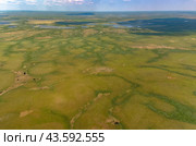 Arctic tundra in summer from an altitude of 2000 meters. Cloudy sky. Variety of colors and landscapes. The vastness of pristine nature. Shadow from the clouds. Стоковое фото, фотограф Владимир Ендовицкий / Фотобанк Лори