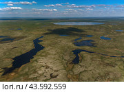 Arctic tundra in summer from an altitude of 2000 meters. Cloudy sky. Variety of colors and landscapes. The vastness of pristine nature. Shadow from the clouds. Стоковое фото, фотограф Владимир Ендовицкий / Фотобанк Лори