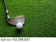 A banner with a view of a green lawn, on which lies a white ball and a metal golf club. An advertisement for a golf game at a country club. Free space for text. Стоковое AI-изображение, AI-художник Photojuli / Фотобанк Лори