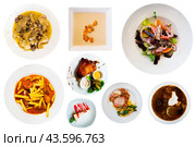 View of many plates with different food over white background. Стоковое фото, фотограф Яков Филимонов / Фотобанк Лори