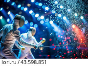 Fencers in the arena with rapiers in their hands during training are fighting a duel. Sports fencing. Fencing is a type of Summer Olympic Games. Стоковое AI-изображение, AI-художник Photojuli / Фотобанк Лори