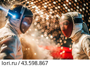 Fencers in the arena with rapiers in their hands during training are fighting a duel. Sports fencing. Fencing is a type of Summer Olympic Games. Стоковое AI-изображение, AI-художник Photojuli / Фотобанк Лори