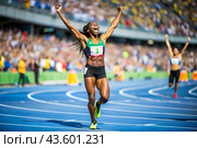 An African-American black athlete won during a sprint race or running at a sporting event. The concept of the Summer Olympic Games. Стоковое AI-изображение, AI-художник Photojuli / Фотобанк Лори