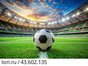 Soccer ball on the green field in soccer stadium. ready for game in the midfield. Стоковое AI-изображение, AI-художник Photojuli / Фотобанк Лори