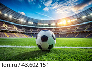 Soccer ball on the green field in soccer stadium. ready for game in the midfield. Стоковое AI-изображение, AI-художник Photojuli / Фотобанк Лори