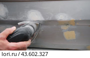 Car body shop. Repair man processes the welding seam using an angle grinder on replaced car part. Professional Body master grind old paint and rust. Rusty damage. Rusting car. Hands with tool close-up. Стоковое видео, видеограф Марина Демидюк / Фотобанк Лори