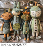 Four handmade dolls made of fabric and decorated with buttons and embroidery. Each doll has a unique design and facial expression that gives them their own personality. They sit on a wooden surface which creates a nice contrast with the texture and colors of the dolls. The dolls range in color from green to taupe, with accents like button detailing and embroidery. Стоковое AI-изображение, AI-художник Анна Кривицкая / Фотобанк Лори