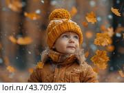 Little boy having fun during stroll in the forest at sunny autumn day. Child playing maple leaves. Baby tossing the leaves up. Active family time on nature. Hiking with little kids. Dry leaves rustle. Стоковое AI-изображение, AI-художник Ирина Михайличенко / Фотобанк Лори