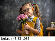 A sweet, beautiful first-grader girl with glasses. In the hands of a bouquet of flowers. The child goes to school for the first time. A child with a backpack, a book and flowers. Back to school. Стоковое AI-изображение, AI-художник Photojuli / Фотобанк Лори
