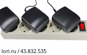 Блок питания в розетке на белом фоне. AC/DC adapter  on white background. Стоковое фото, фотограф Татьяна Д / Фотобанк Лори