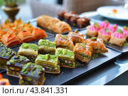 Assorted gourmet pastries on display. Стоковое AI-изображение, AI-художник Иван Рябоконь / Фотобанк Лори