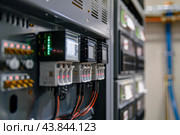 Modern electrical control panel in industrial environment. Стоковое AI-изображение, AI-художник Иван Рябоконь / Фотобанк Лори
