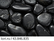 Polished black tourmaline minerals are arranged showing texture and natural patterns. Стоковое AI-изображение, AI-художник Иван Рябоконь / Фотобанк Лори