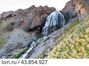 The stormy waterfall "maiden braids" falling from a vertical rocky wall. The mountains of the North Caucasus. Russia. Стоковое фото, фотограф Константин Лабунский / Фотобанк Лори