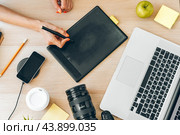 Young female photographer artist working at home office. Stay at home. Coronavirus. Стоковое фото, фотограф Сергей Толмачёв / Фотобанк Лори