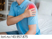 Dislocation of the shoulder, joint inflammation, arthritis and degenerative changes, man with pain in hand at home. Стоковое фото, фотограф Станислав Тарко / Фотобанк Лори