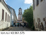 View of the Clock tower and old street in Vyborg, Russia (2024 год). Редакционное фото, фотограф Евгений Харитонов / Фотобанк Лори