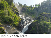 Latefossen is one of the most visited waterfalls in Norway and is located near Skare and Odda in the region Hordaland, Norway. Consists of two separate streams flowing down from the lake Lotevatnet. (2019 год). Стоковое фото, фотограф Андрей Армягов / Фотобанк Лори