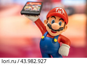 MOSCOW, RUSSIA - October 3, 2020: Super Mario Bros figure character.Super Mario is a Japanese platform video game series and media franchise created by Nintendo and featuring their mascot, Mario. Редакционное фото, фотограф Андрей Армягов / Фотобанк Лори