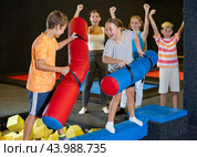 Tween girl having fun on battle beam with friend. Стоковое фото, фотограф Яков Филимонов / Фотобанк Лори