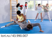 Boy twists the arm of an coach during self-defense training in gym. Стоковое фото, фотограф Яков Филимонов / Фотобанк Лори