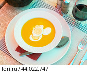 Pureed vegetable soup served with boiled eggs in bowl with spoon and glass of wine. Стоковое фото, фотограф Яков Филимонов / Фотобанк Лори