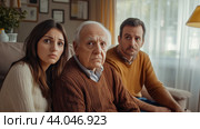 Family members express concern during a heartfelt conversation in a cozy living room. Стоковое AI-изображение, AI-художник Сергей Толмачёв / Фотобанк Лори
