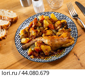 Lunch is served on plate - pieces of young rabbit cooked with segments of potato. Close-up. Стоковое фото, фотограф Яков Филимонов / Фотобанк Лори
