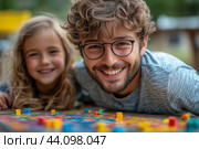 Family members enjoy a board game outdoors on a sunny day, showcasing fun and joy. Стоковое AI-изображение, AI-художник Сергей Толмачёв / Фотобанк Лори