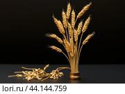 Golden wheat sheaf on black background. Стоковое AI-изображение, AI-художник Иван Рябоконь / Фотобанк Лори