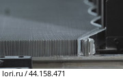 Close-up view of a tightly woven metal mesh, which undergoes tension as a consequence of the machinery in action during the process of furniture and ceiling production. Стоковое видео, видеограф Strunov David / Фотобанк Лори